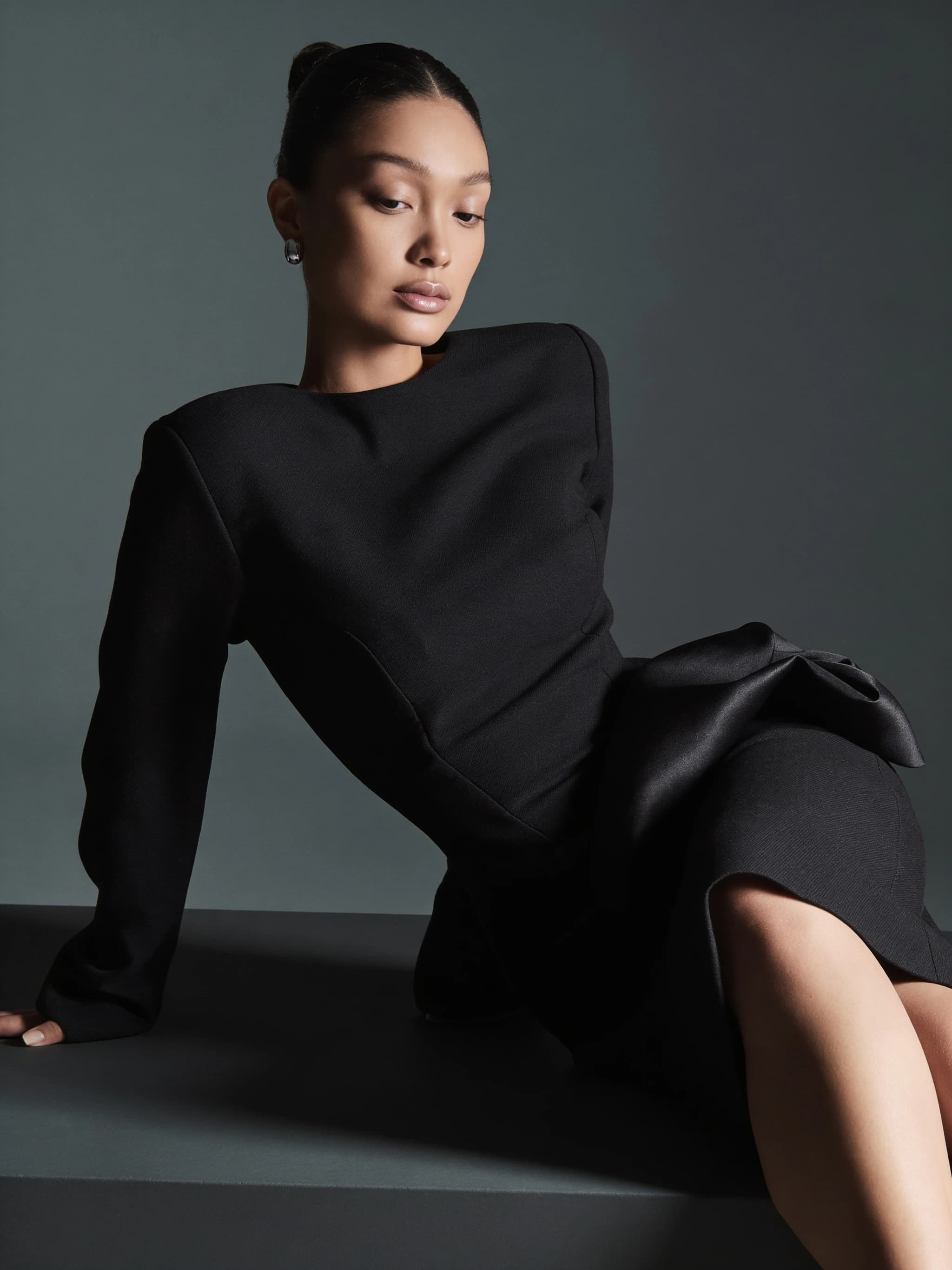 Model wearing a black midi dress