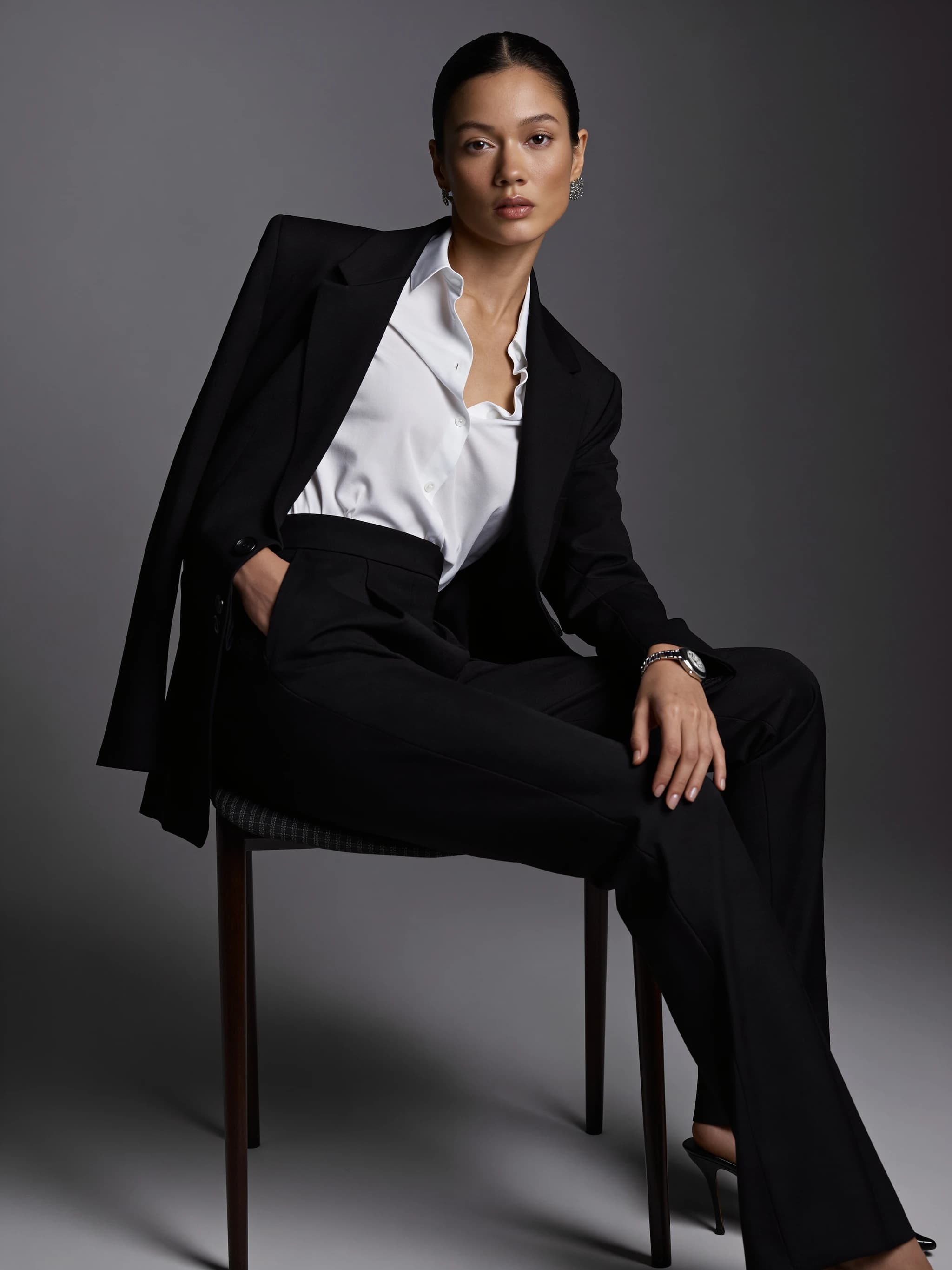 Model wearing tailored black trousers